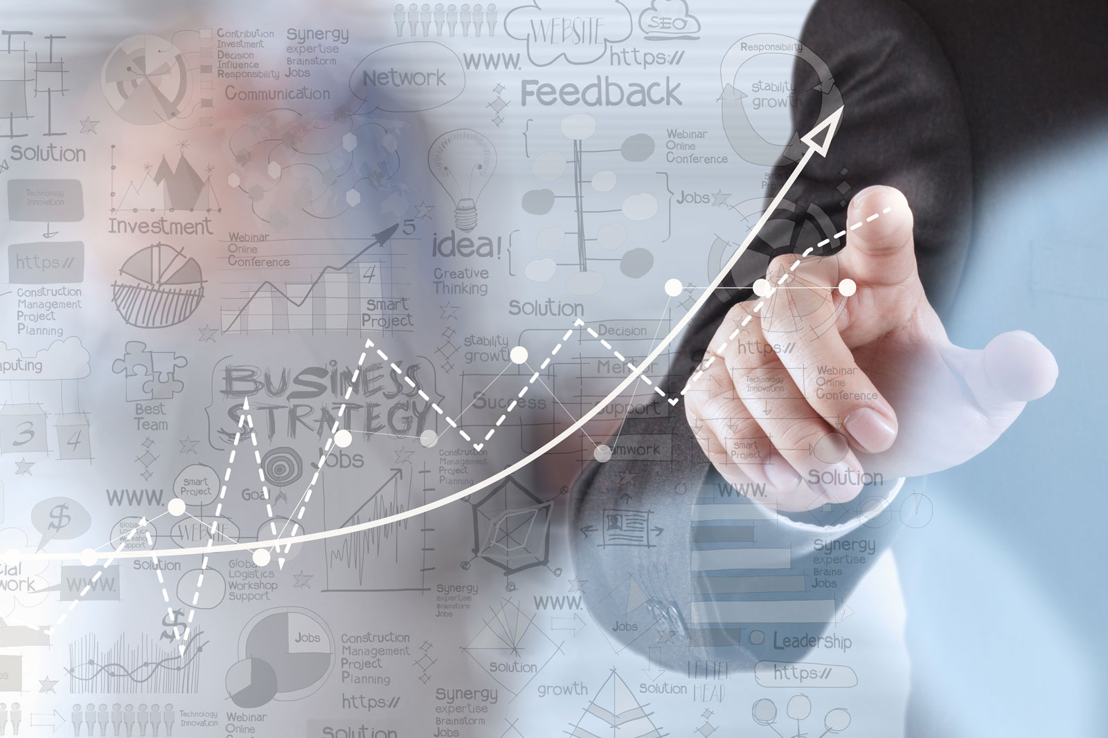 business mans hand on screen doing a graph